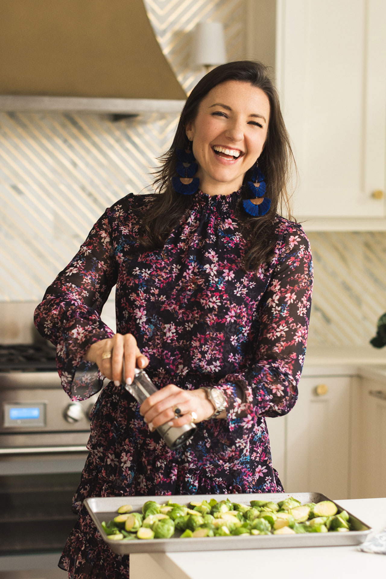 Isabel Smith seasoning veggies in the kitchen